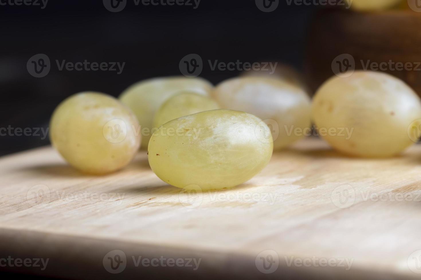 Homemade green unwashed grapes on a board photo