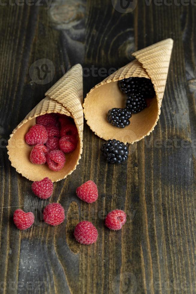 Ripe red raspberries in a crispy waffle cone photo