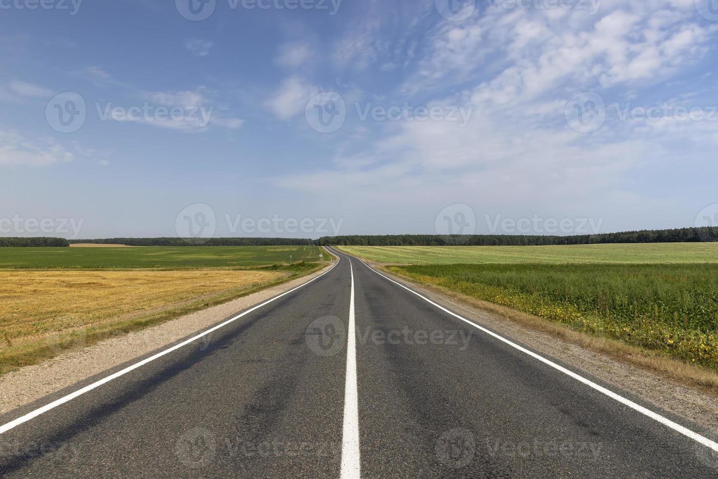 Narrow paved road for cars photo