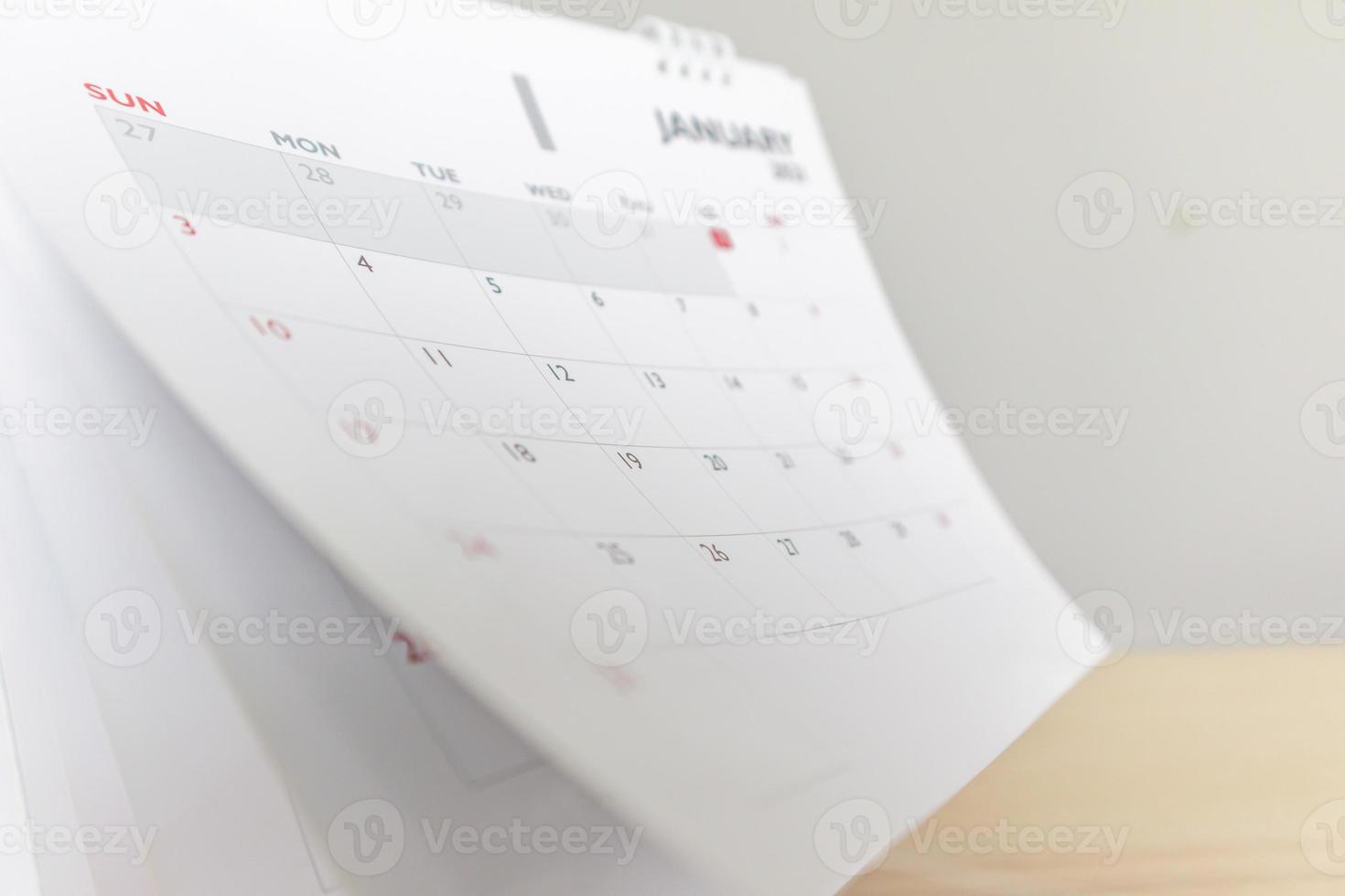 Calendar page flipping sheet on wood table background business schedule planning appointment meeting concept photo