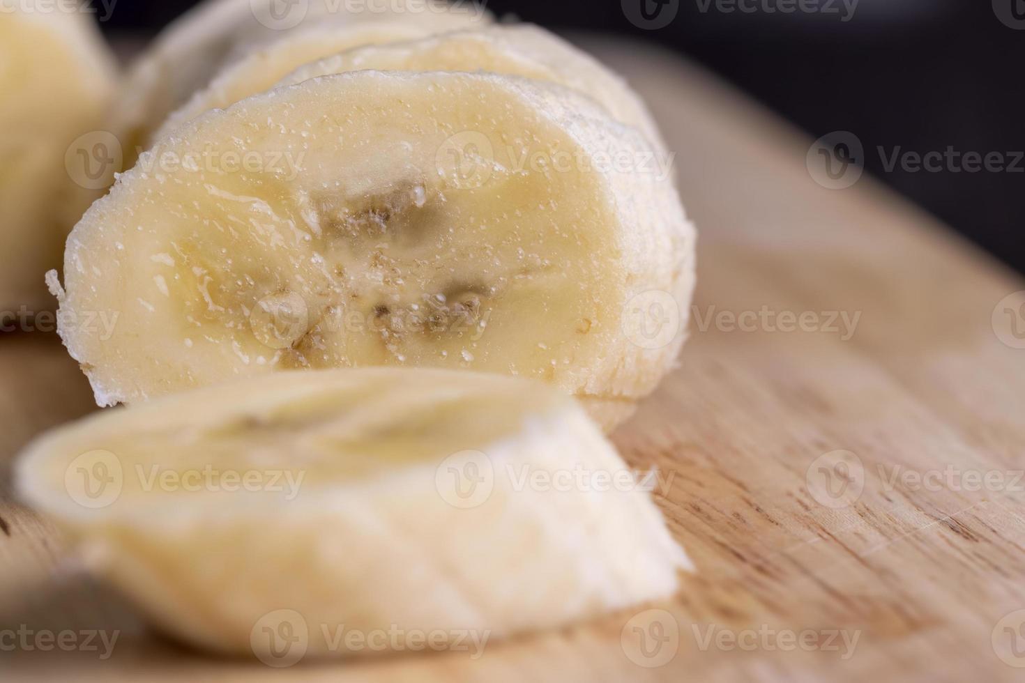 Sliced ripe banana on a cutting board photo