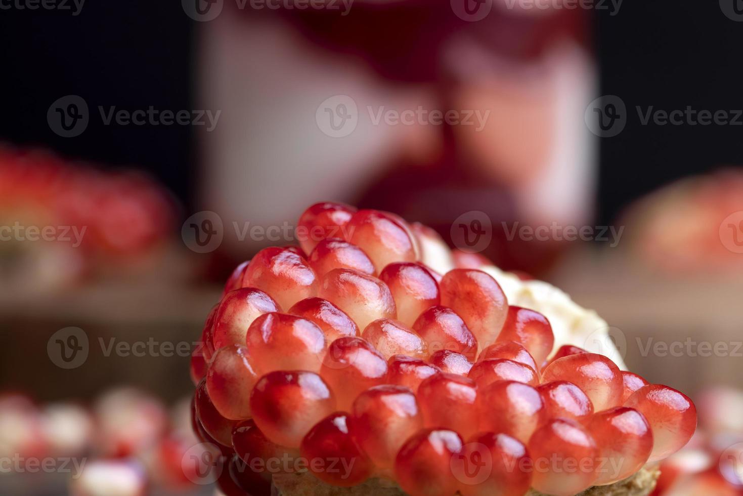Red pomegranate seeds on the table and the board photo