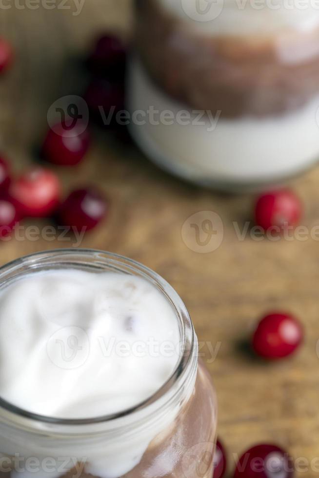 Yogurt with plum jam in a jar photo