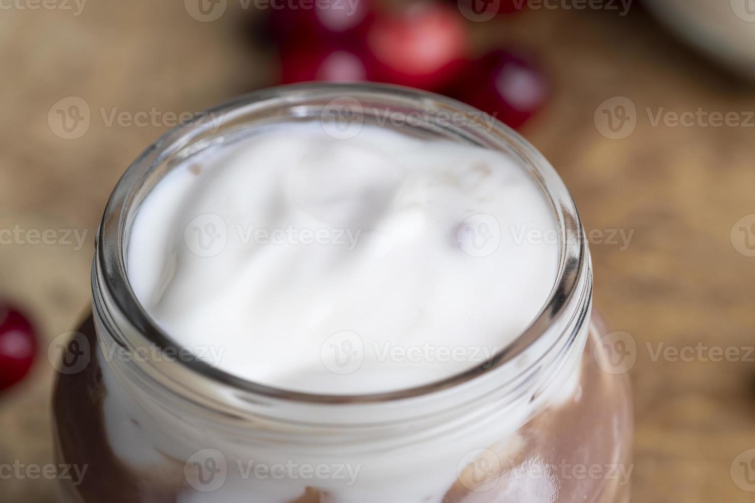 Yogurt with plum jam in a jar photo