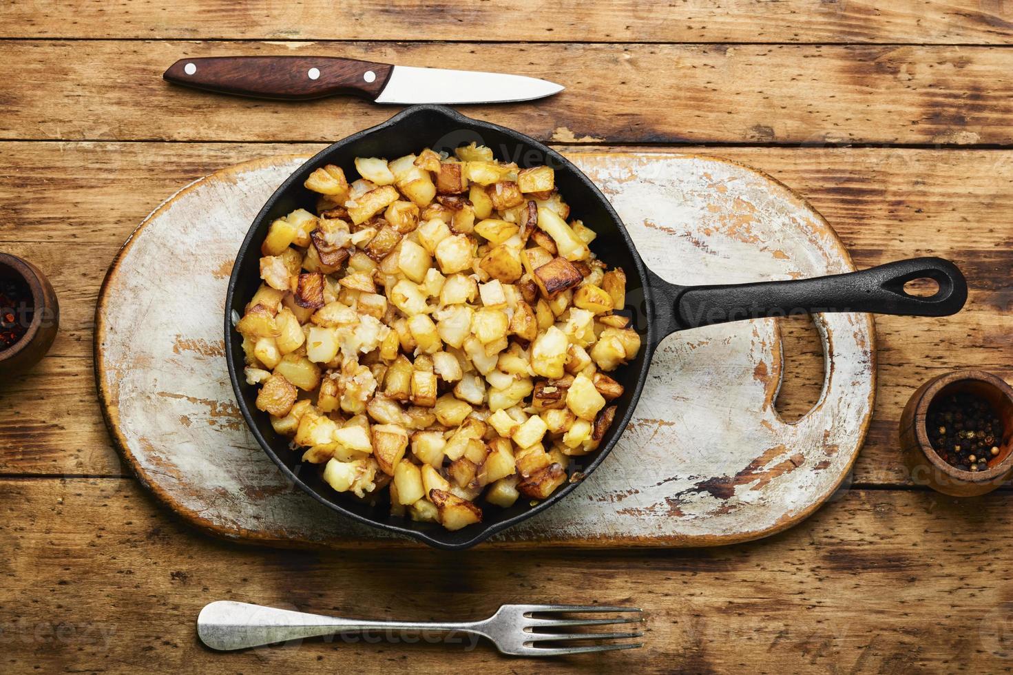 Roasted potatoes in iron skillet photo