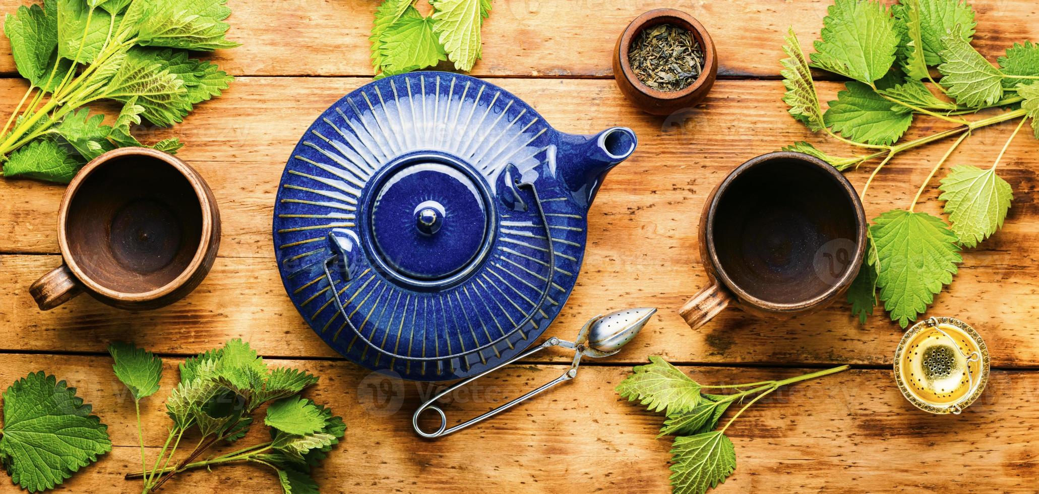 Healthy herbal tea with nettle on wooden table photo