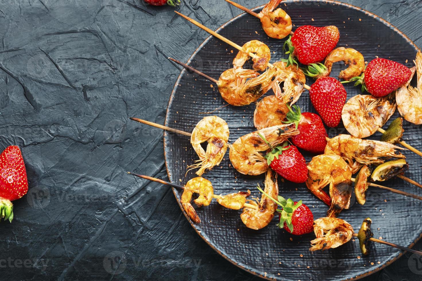 Grilled shrimps on skewers with strawberries,BBQ shrimp photo