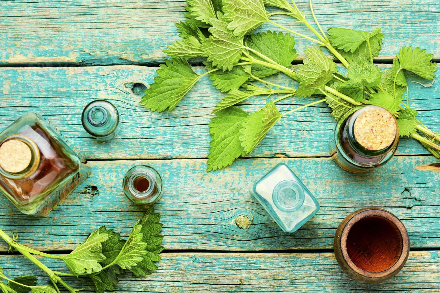 Glass bottle of nettle tincture,flat lay photo