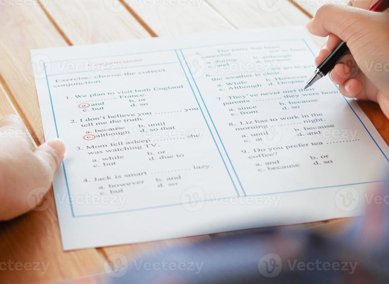 English grammar sheet on wooden table photo