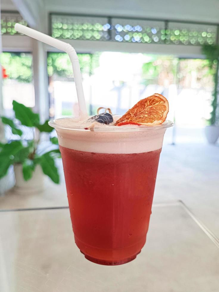 glass of fresh cold brew mixed fruit on table photo