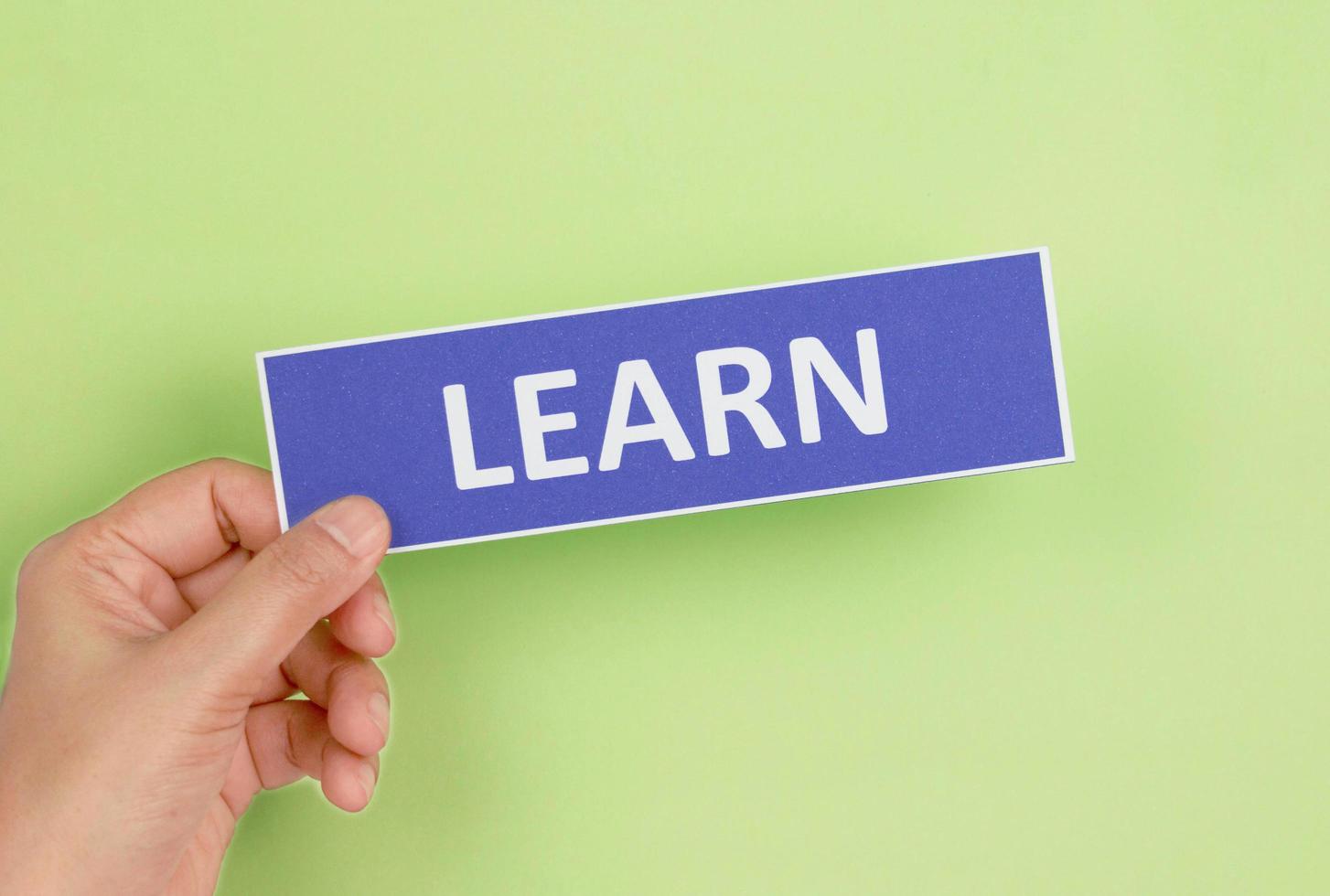 hand holding colorful sign of English learning skills photo