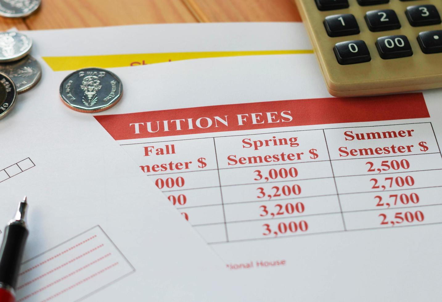 close up school tuition fees on wooden table photo