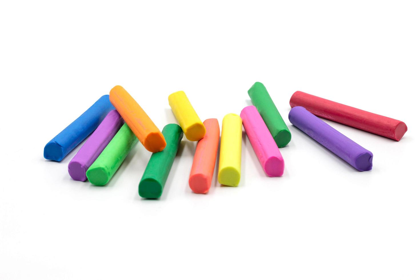 multi colors of clay sticks on white background photo