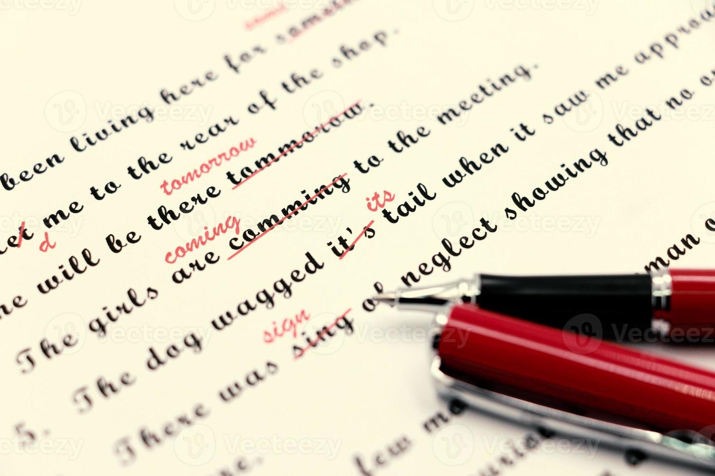 proofreading of English sentences on white paperwork photo