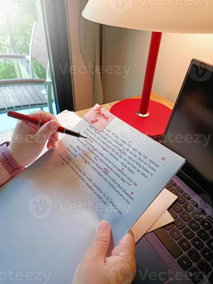 paperwork for proofreading on wooden table photo