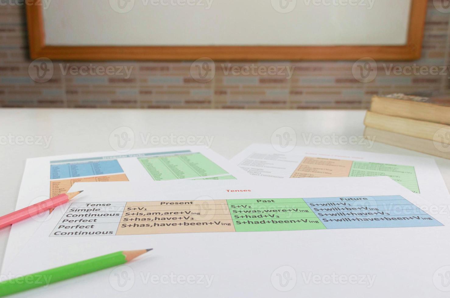 colorful English grammar sheets on white table in classroom photo