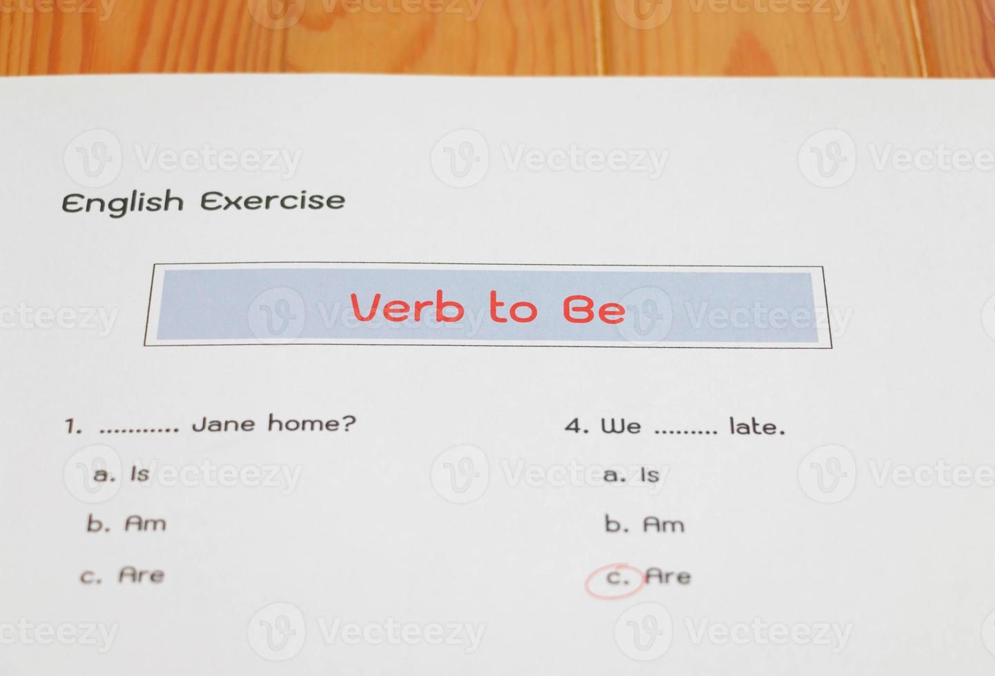 English grammar test sheet on wooden table photo