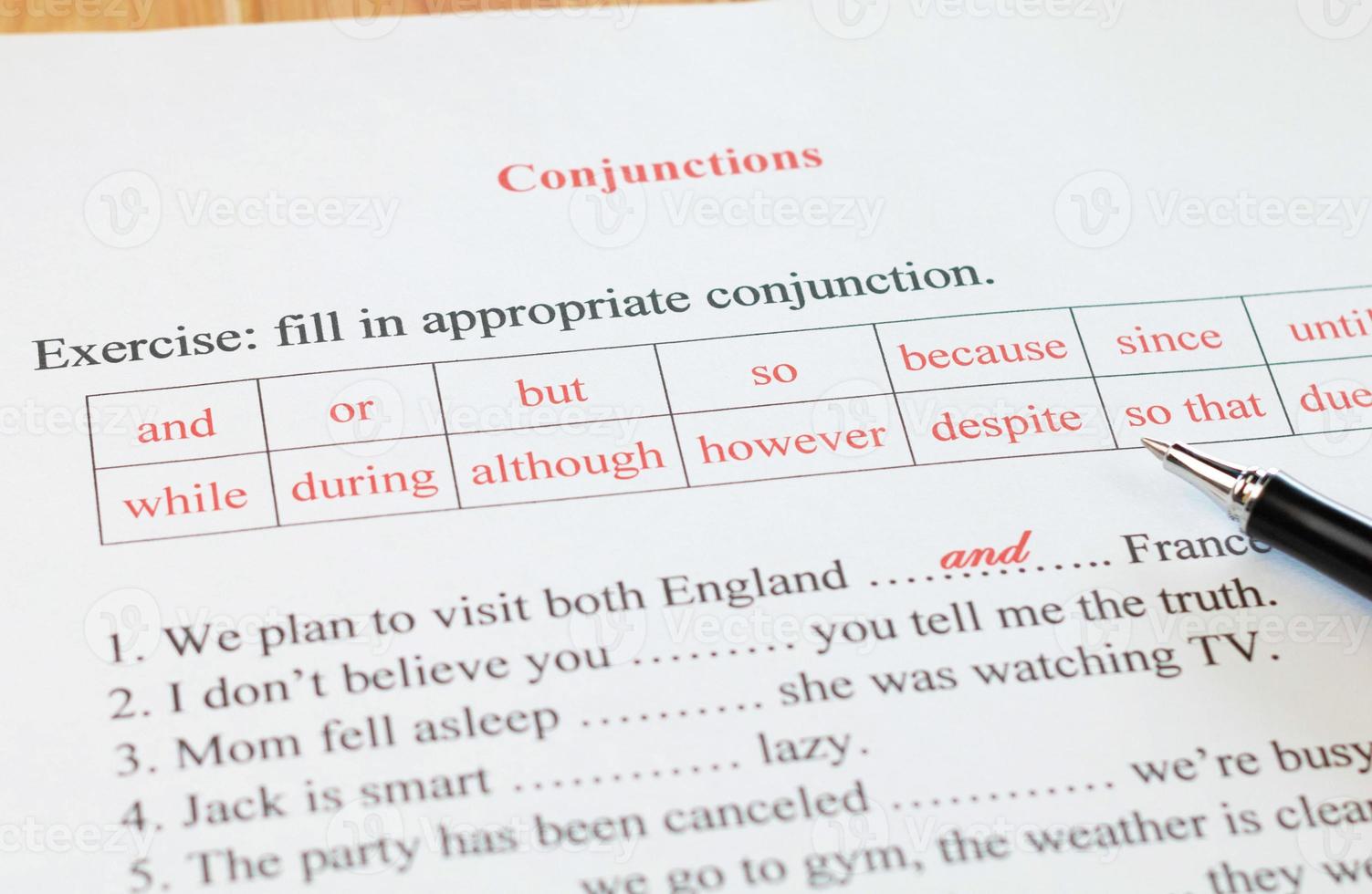 English grammar sheet on wooden table photo