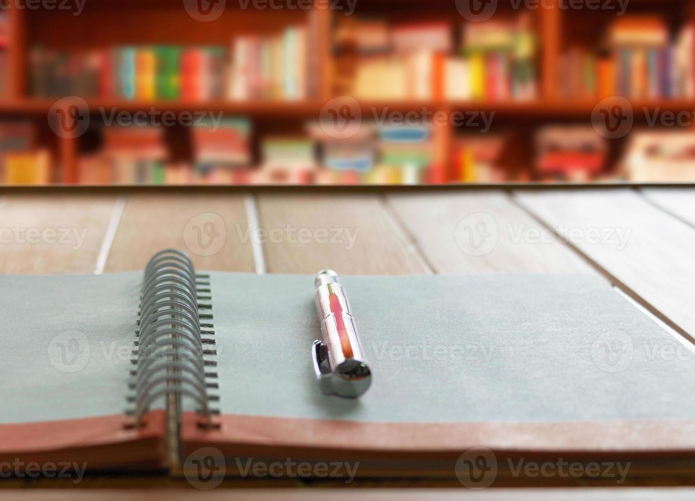 pen on notebook with white loop on wooden table photo