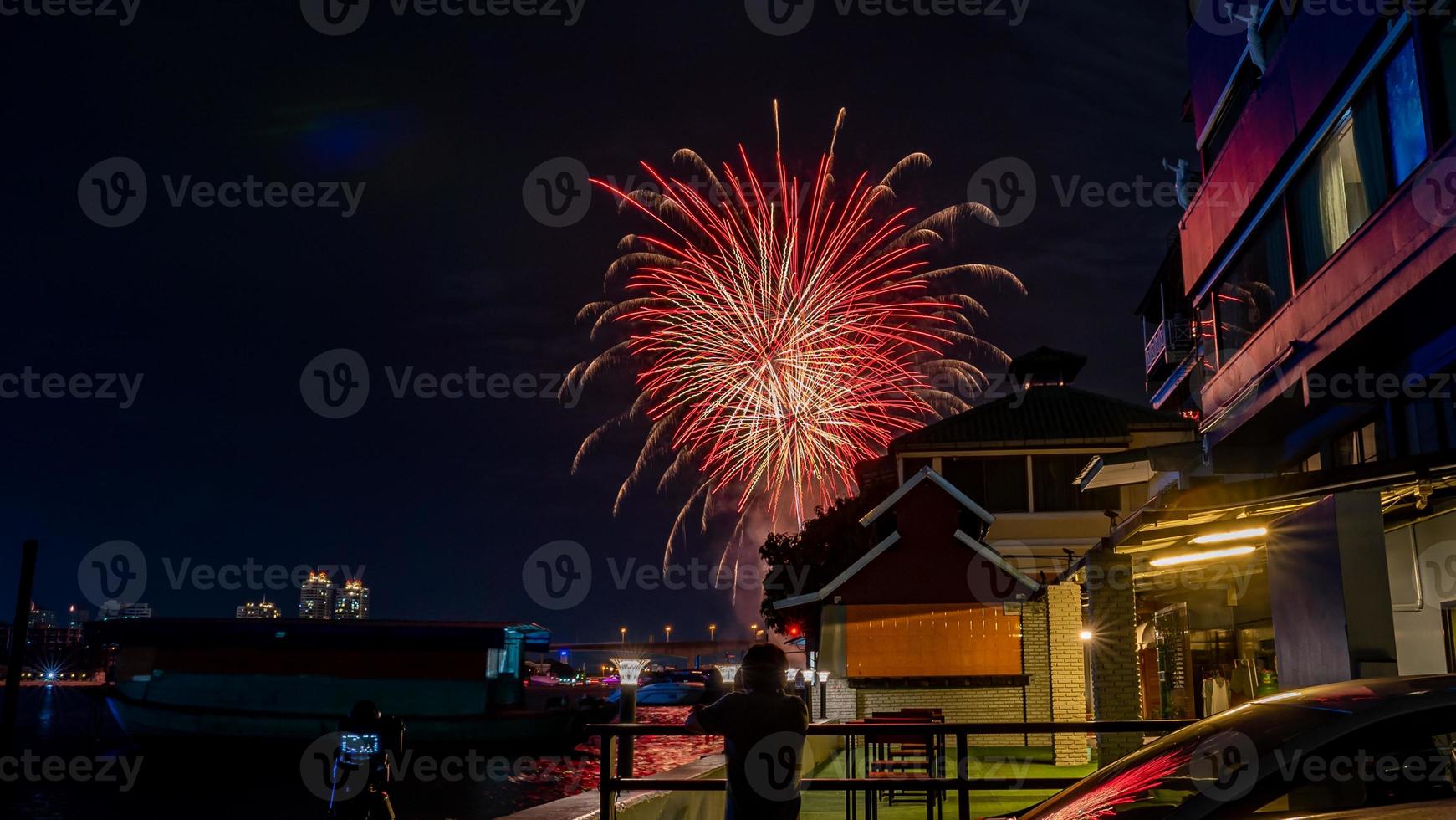 fireworks on the river in the dark sky photo