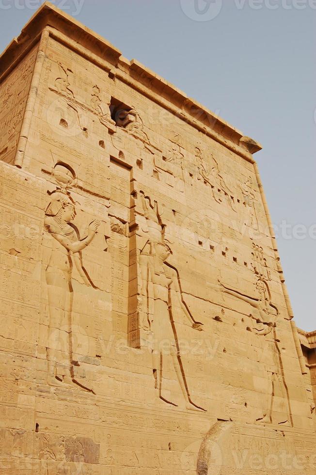 Carving Isis, Horus and Pharaoh on pylon in Philae temple, Egypt photo