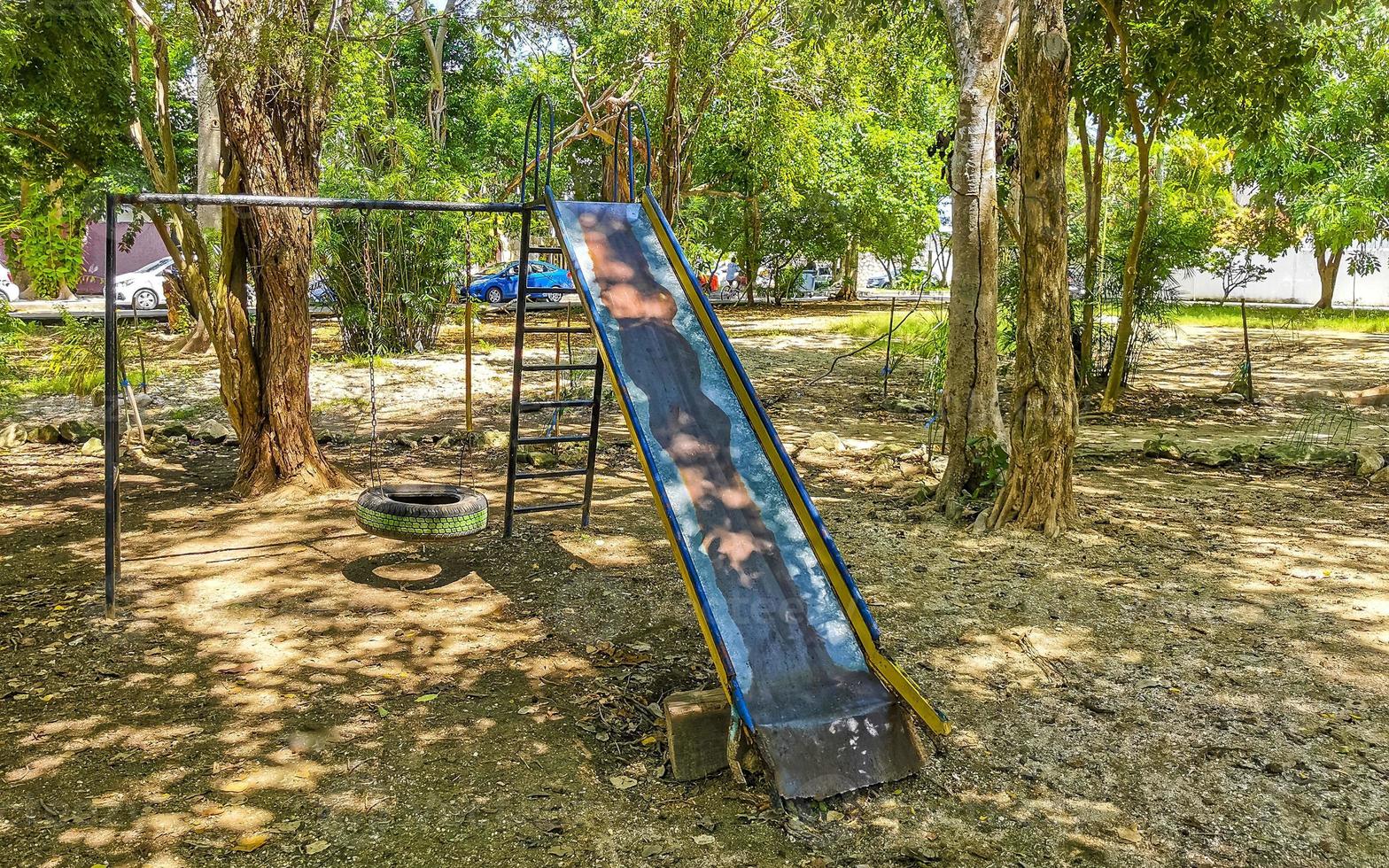 Green city park playground bench slide swing Playa del Carmen. photo