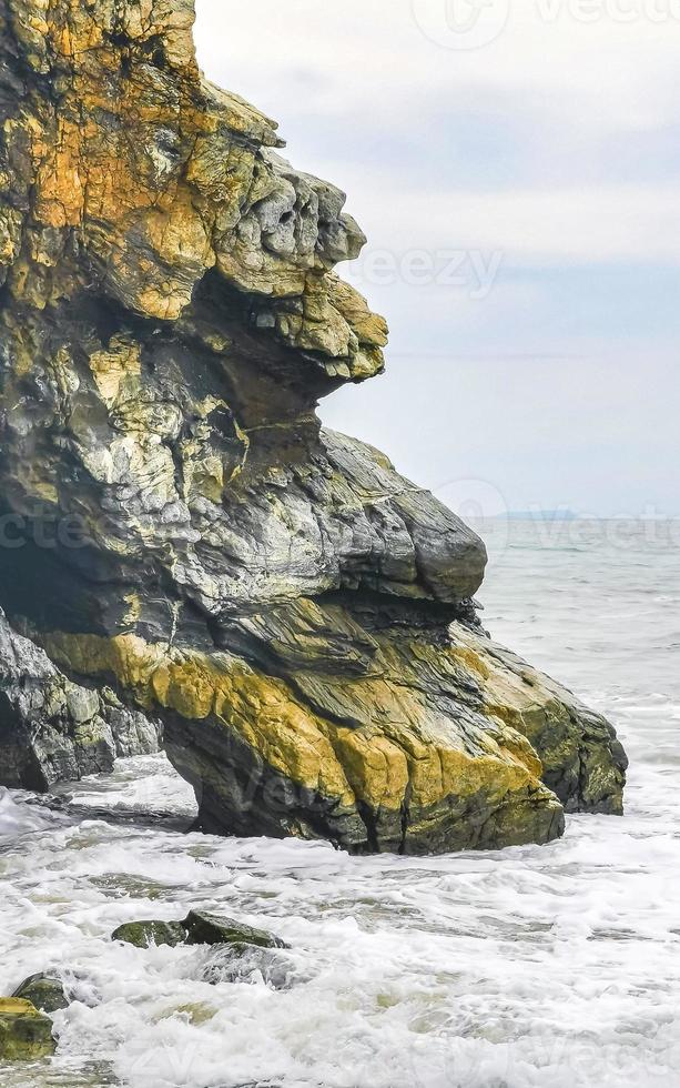 Beautiful surfer waves rocks cliffs at beach Puerto Escondido Mexico. photo