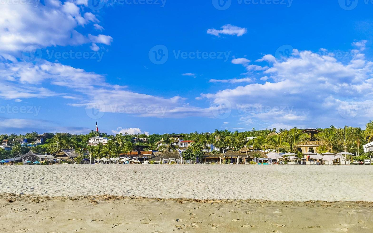 Palms parasols sun loungers beach resort Zicatela Puerto Escondido Mexico. photo