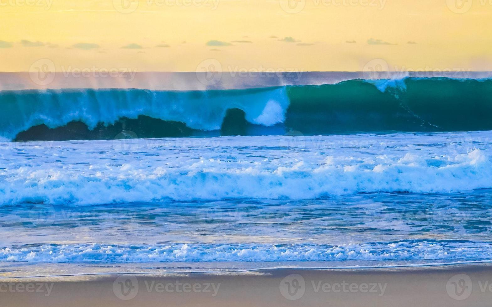 Colorful golden sunset big wave and beach Puerto Escondido Mexico. photo