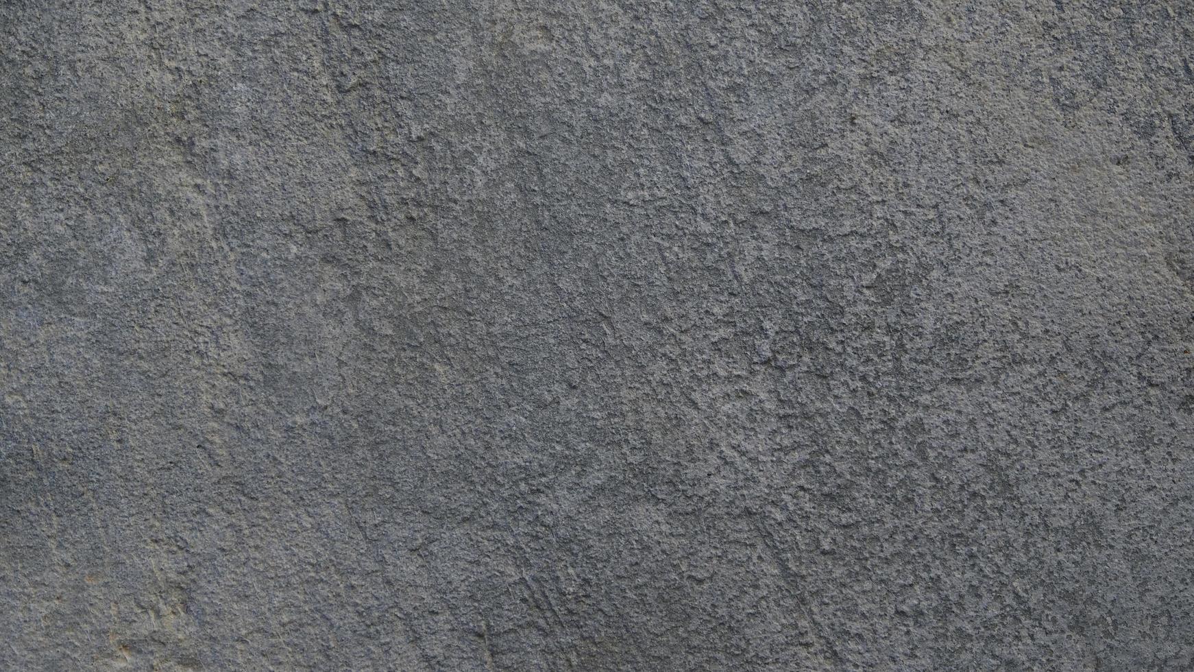 Textured gray concrete background. Old wall or floor made of dark gray cement. Scuffed and cracked. Copy space. Attrition. photo