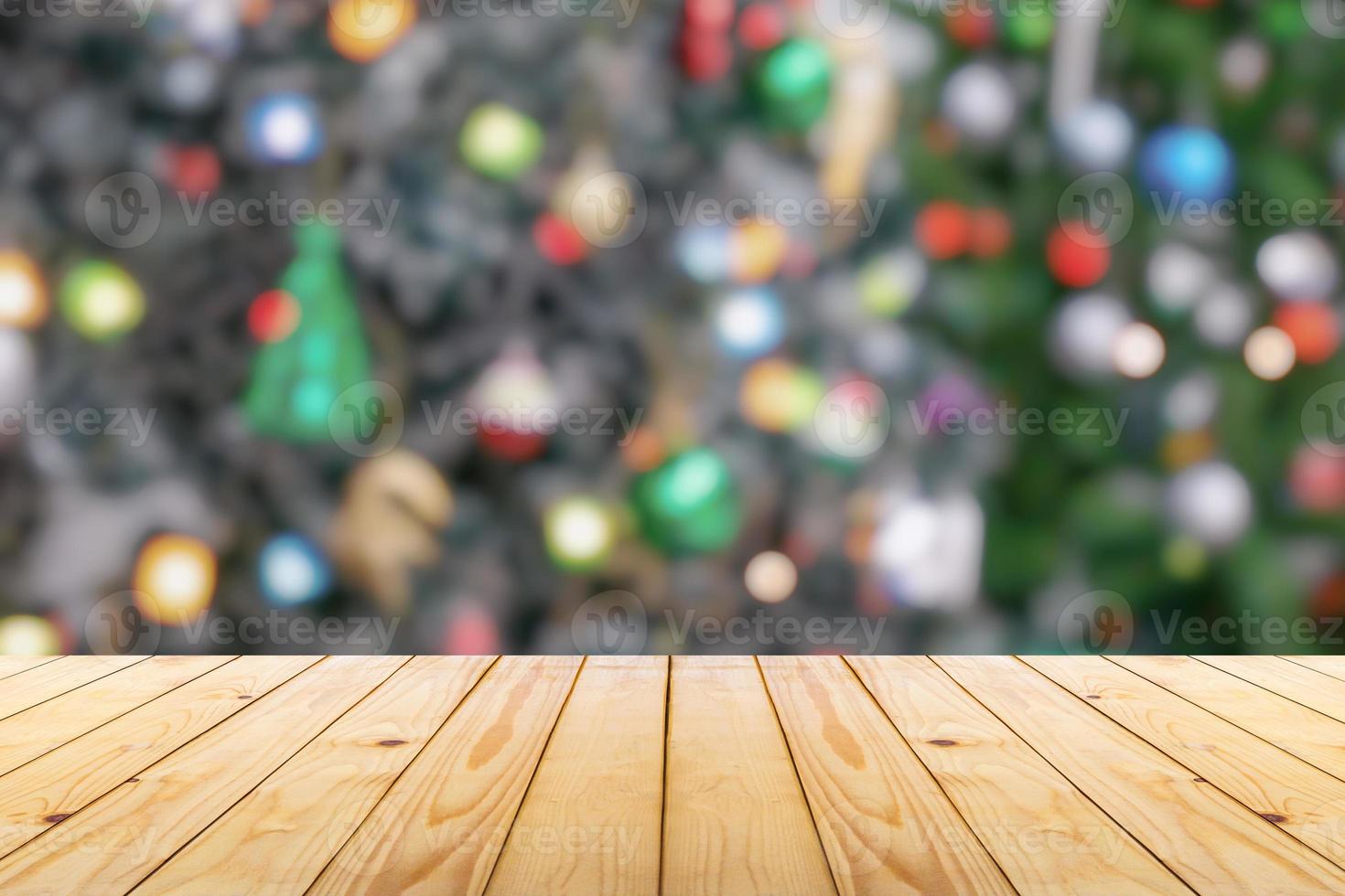 Empty wood table top with blur Christmas tree with bokeh light background photo