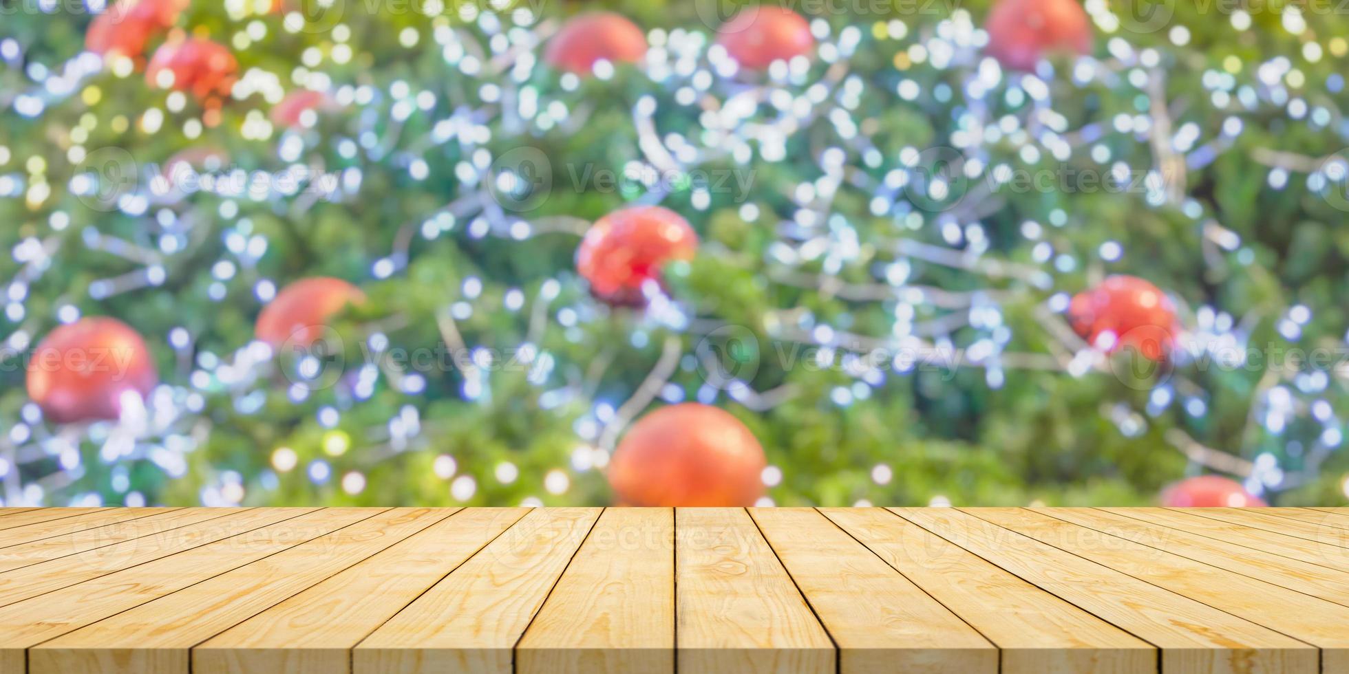 Empty wood table top with blur Christmas tree with bokeh light background photo