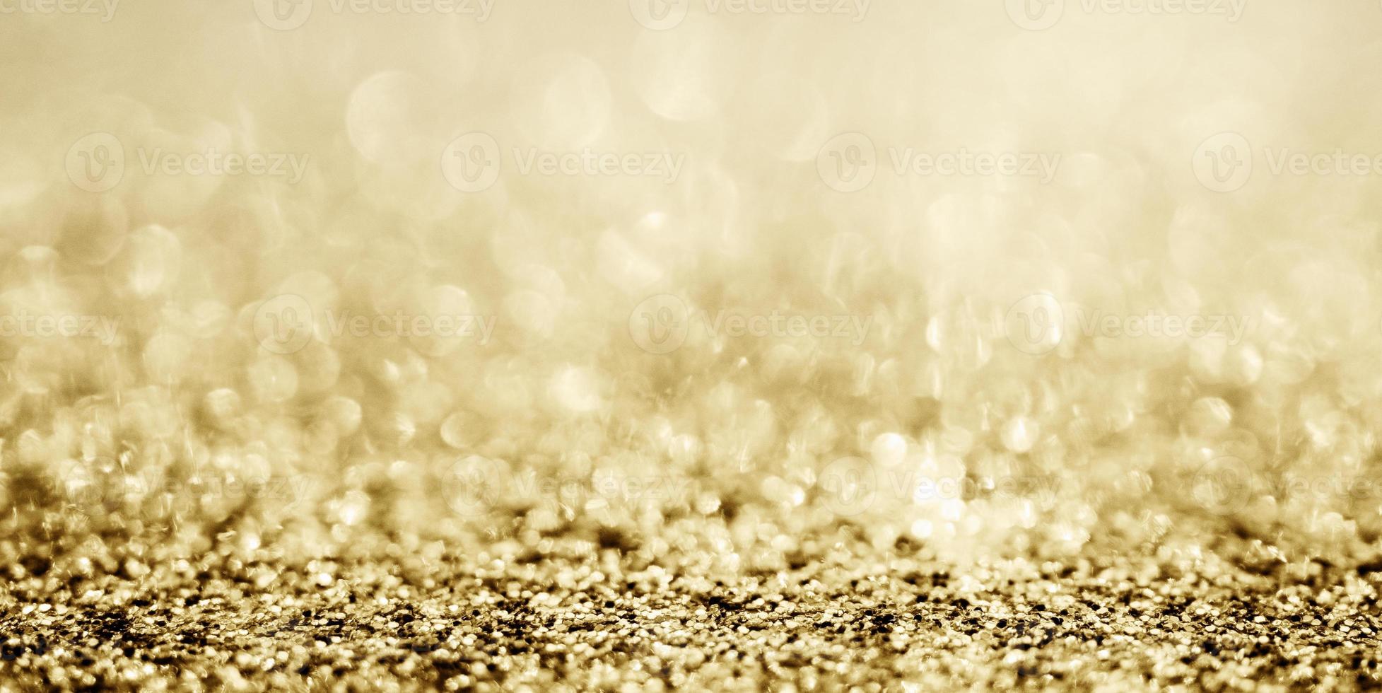 Abstract gold glitter sparkle with bokeh background photo