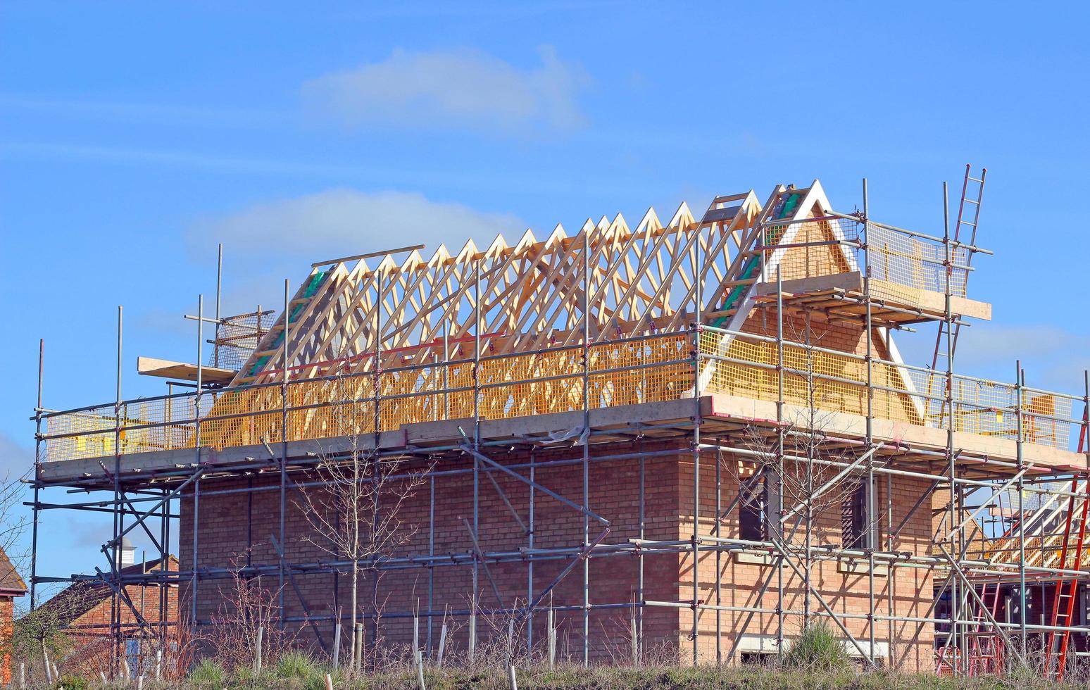 New build house. House being built with scaffolding. photo