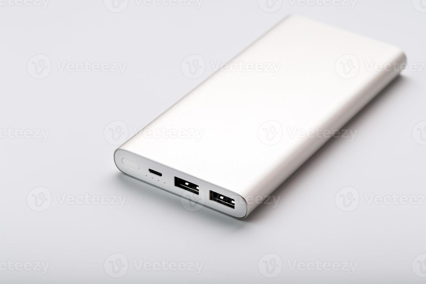 Powerbank for charging mobile devices with cable, on a white background. photo