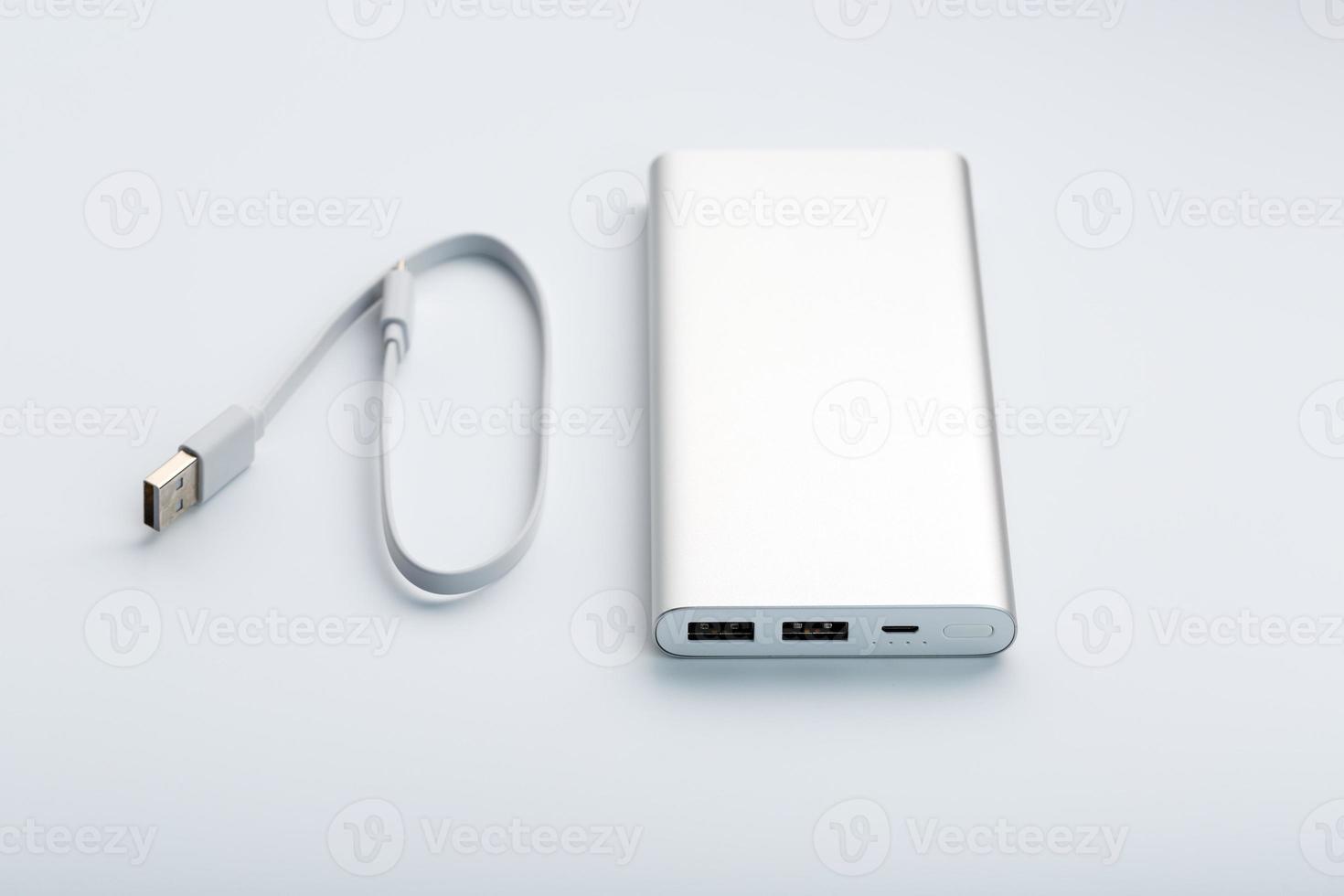 Powerbank for charging mobile devices with cable, on a white background. photo