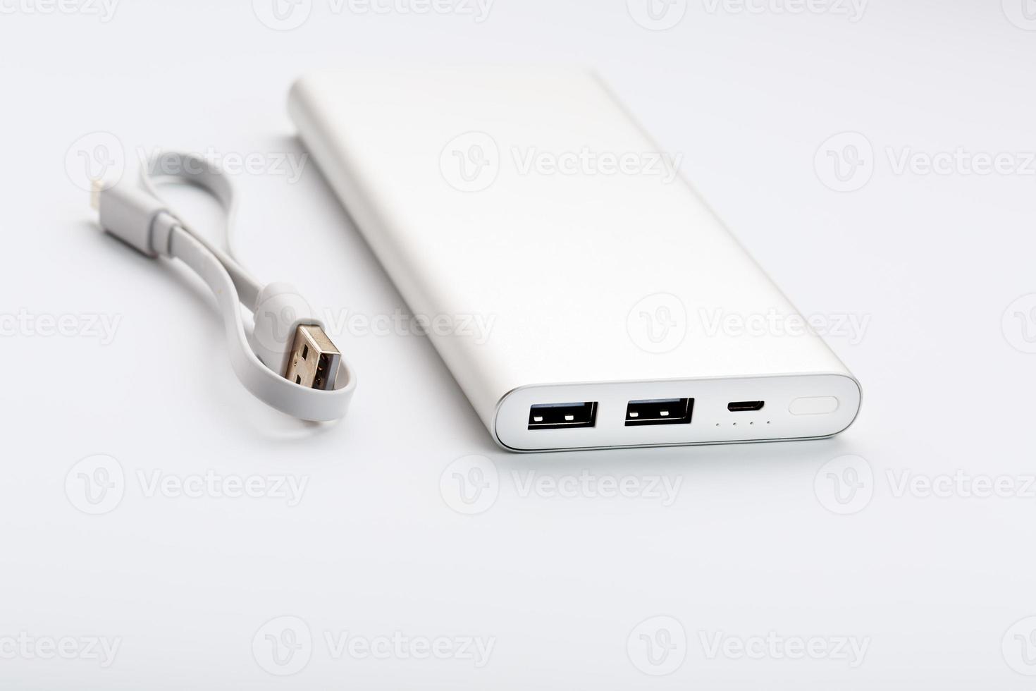 Power Bank for charging your smartphone on a white background. Universal external battery for gadgets free space and minimalistic composition. photo