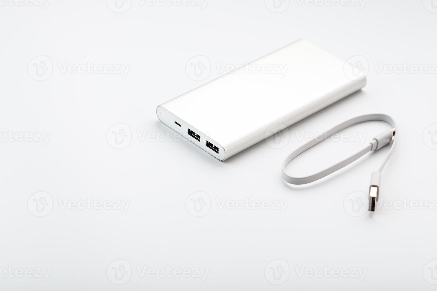 Power Bank for charging your smartphone on a white background. Universal external battery for gadgets free space and minimalistic composition. photo