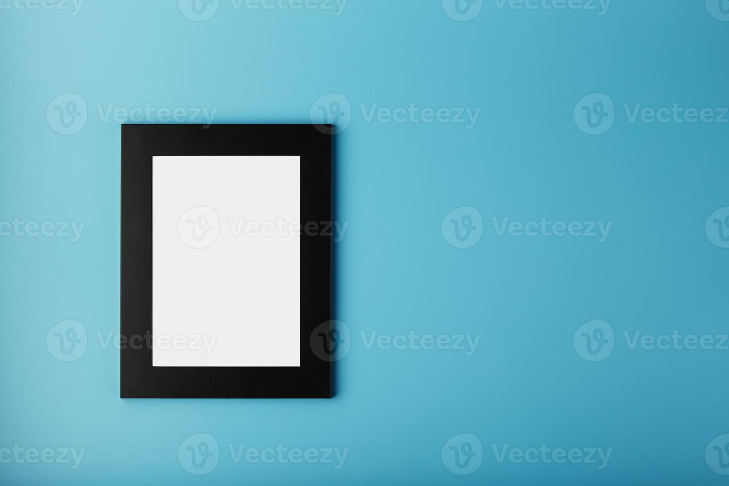 Black photo frame with empty space on a blue background.