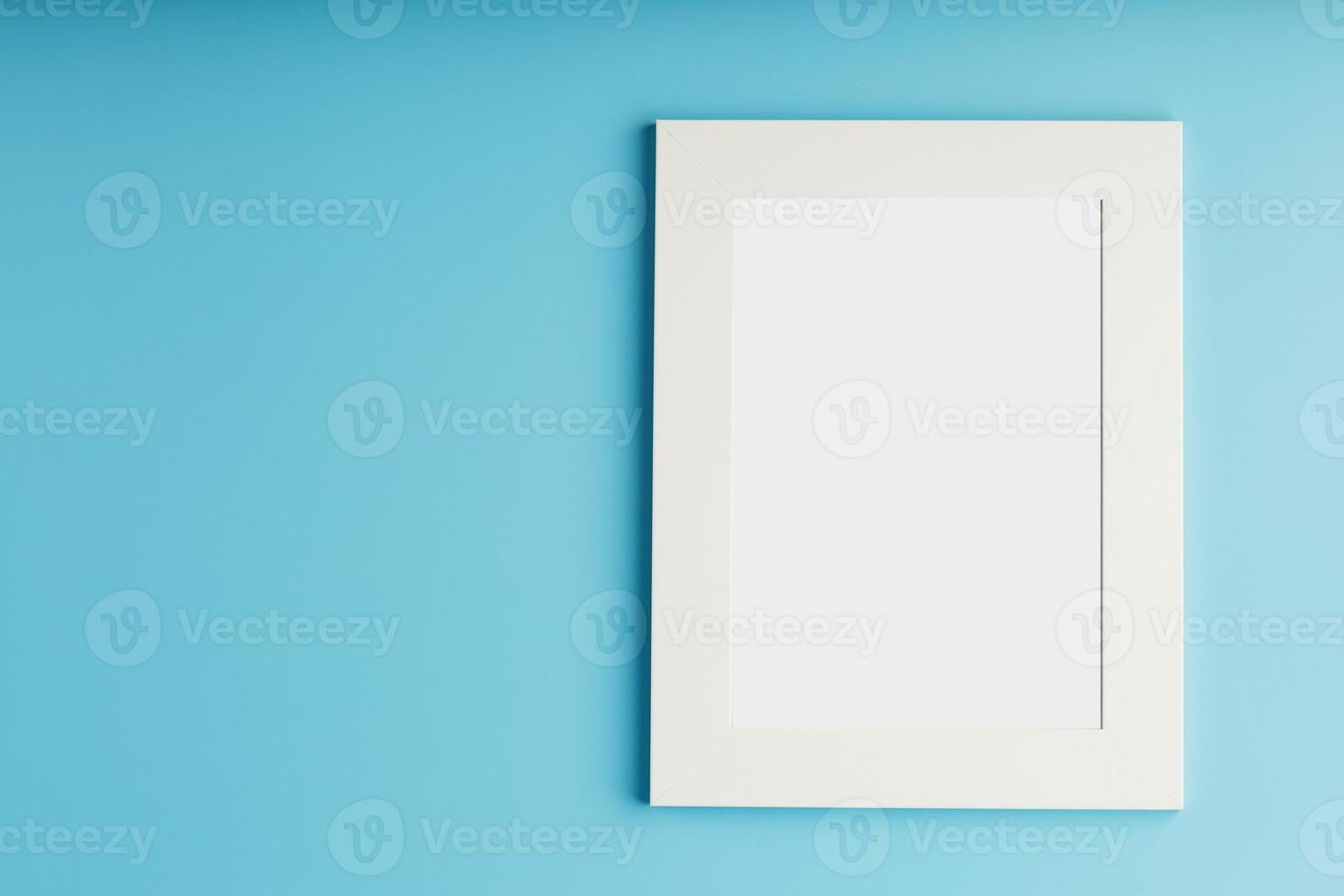 White and black photo frame with empty space on a blue background.