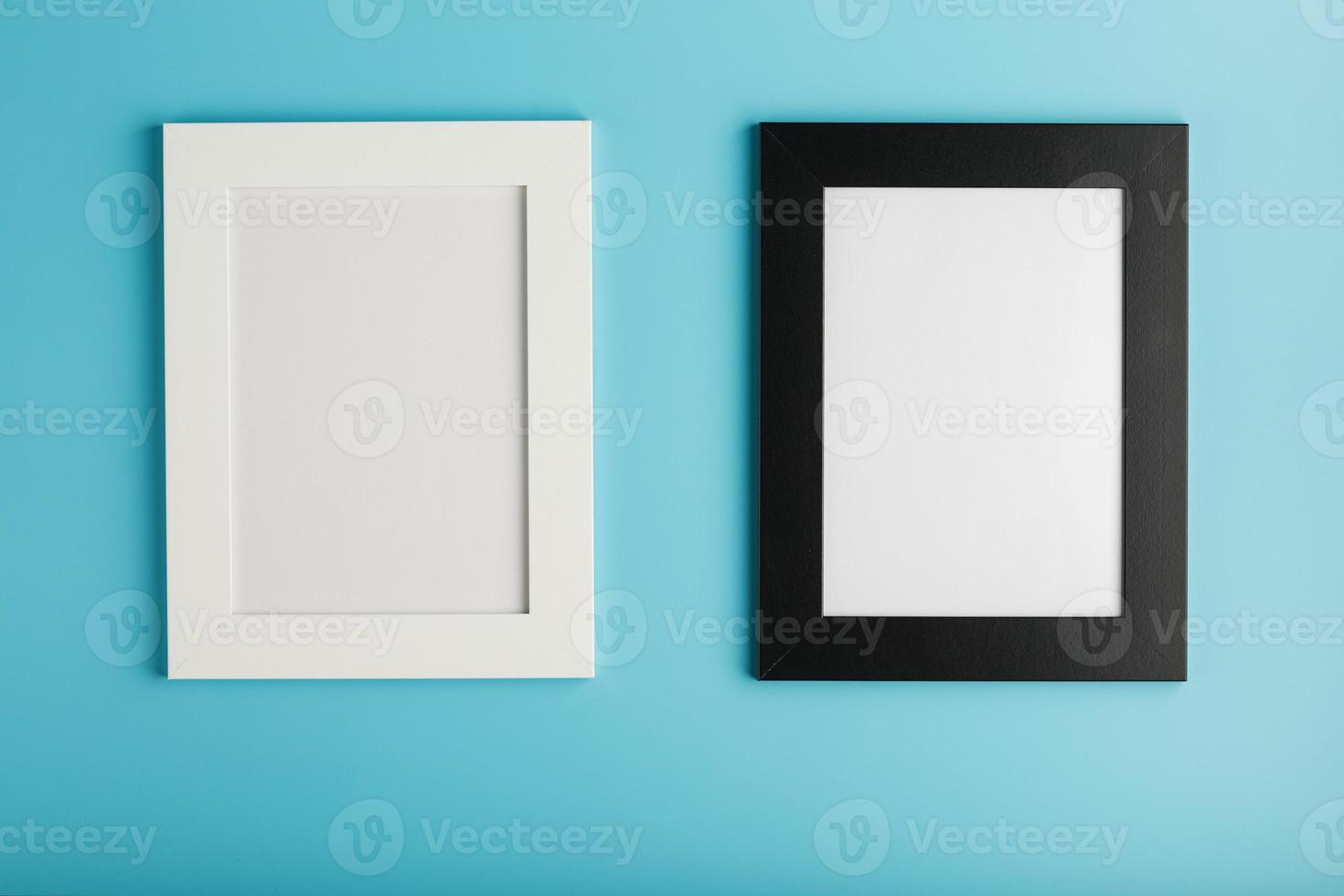 Black and white photo frame with free space on a blue background.