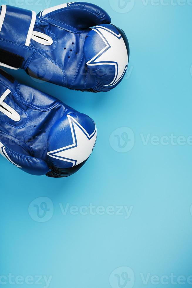 A pair of leather Boxing gloves on a blue background, free space. photo