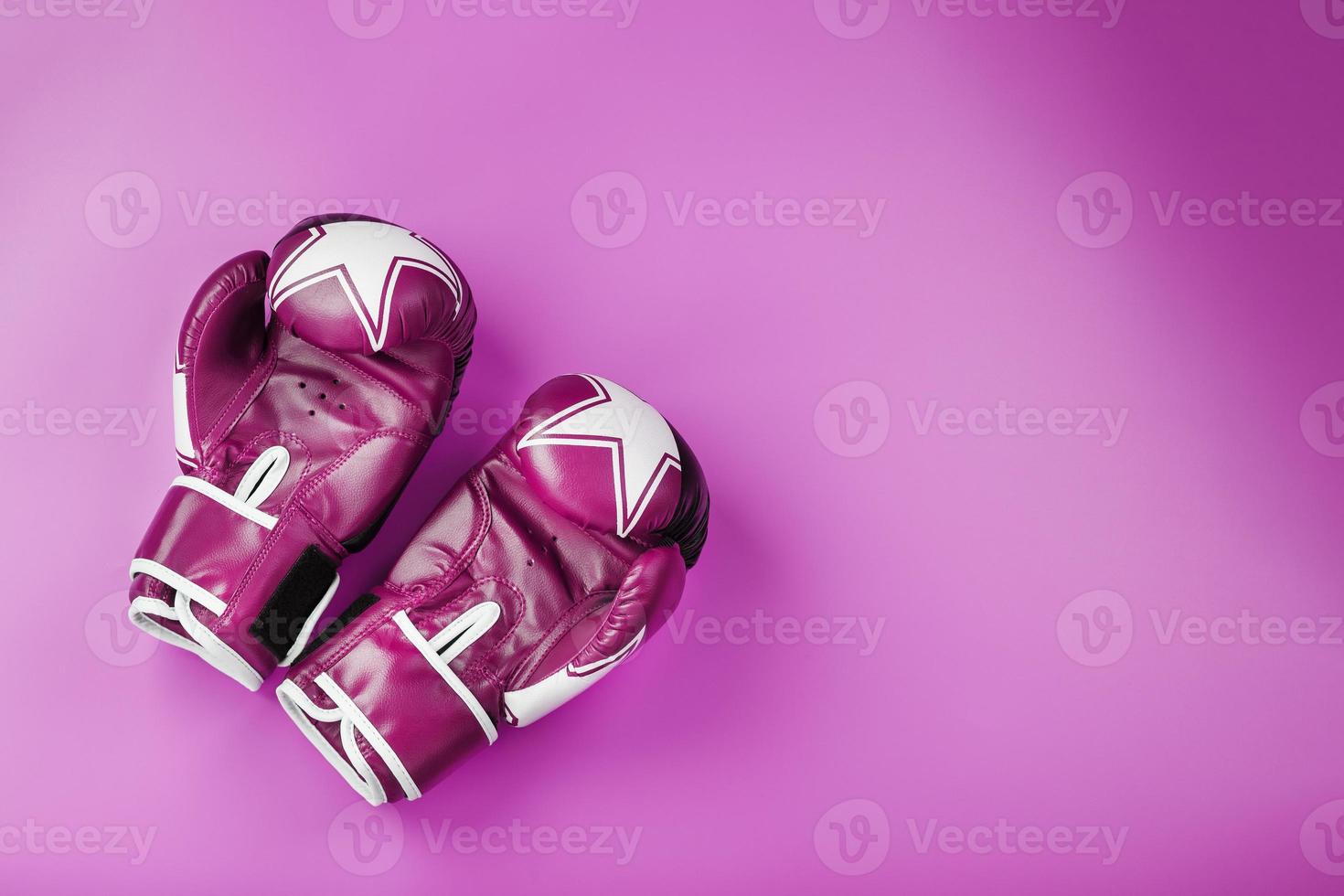 Pink Boxing gloves on a pink background, free space. photo