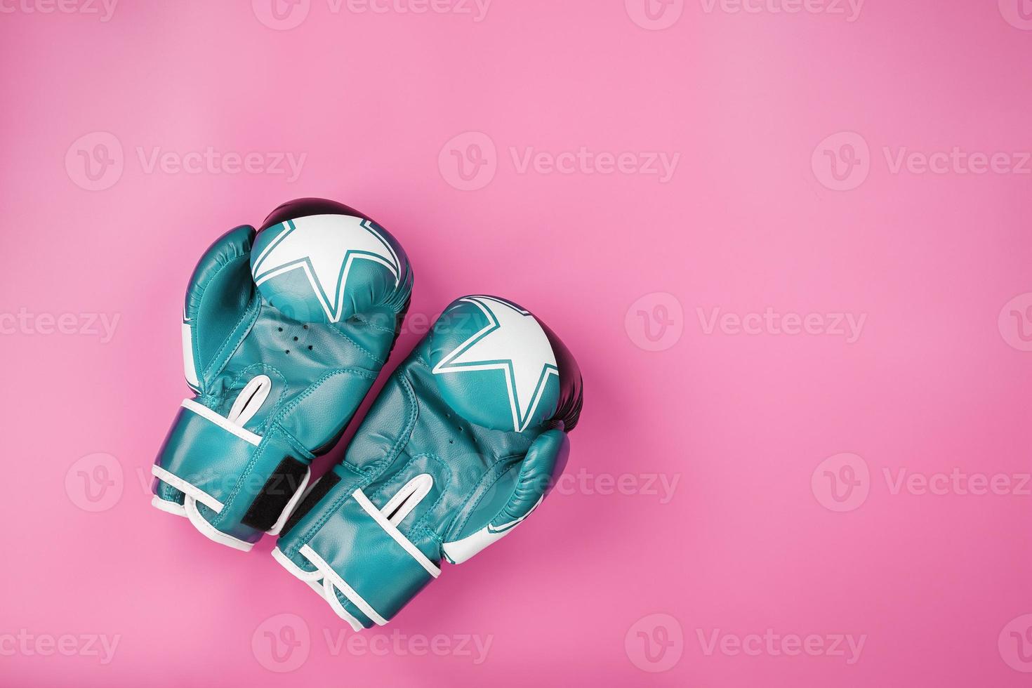 Blue Boxing gloves on a pink background, free space. photo