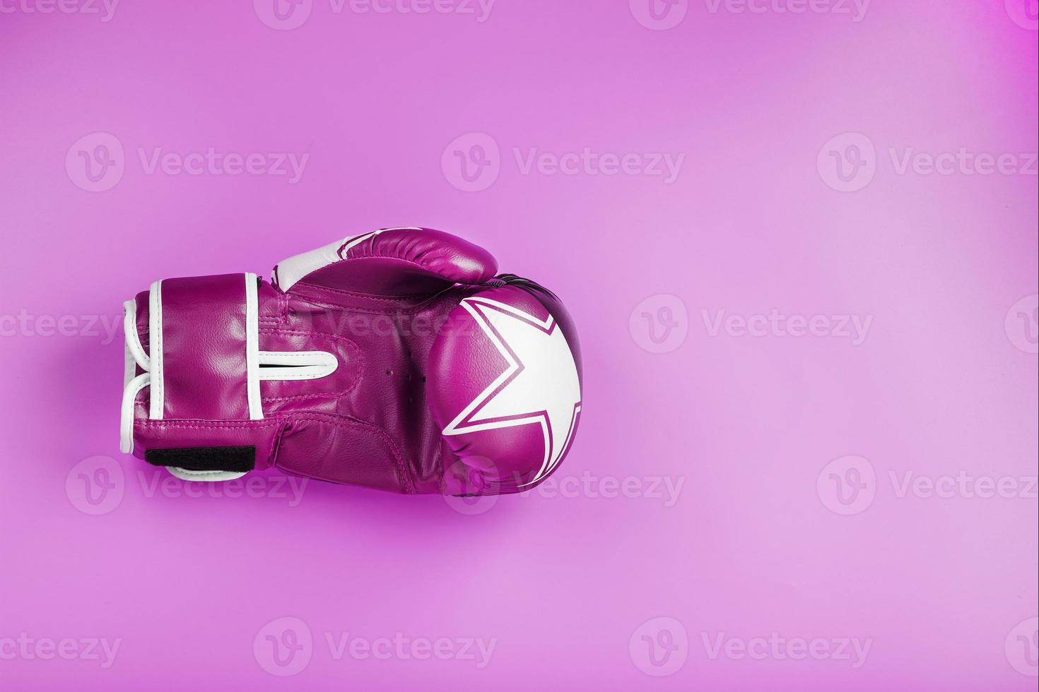 Pink Boxing gloves on a pink background, free space. photo