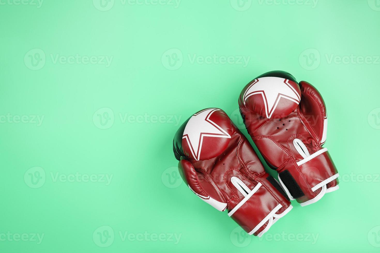 Boxing red gloves on a green background, free space. photo