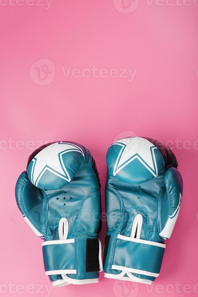 Boxing blue gloves on a pink background. photo