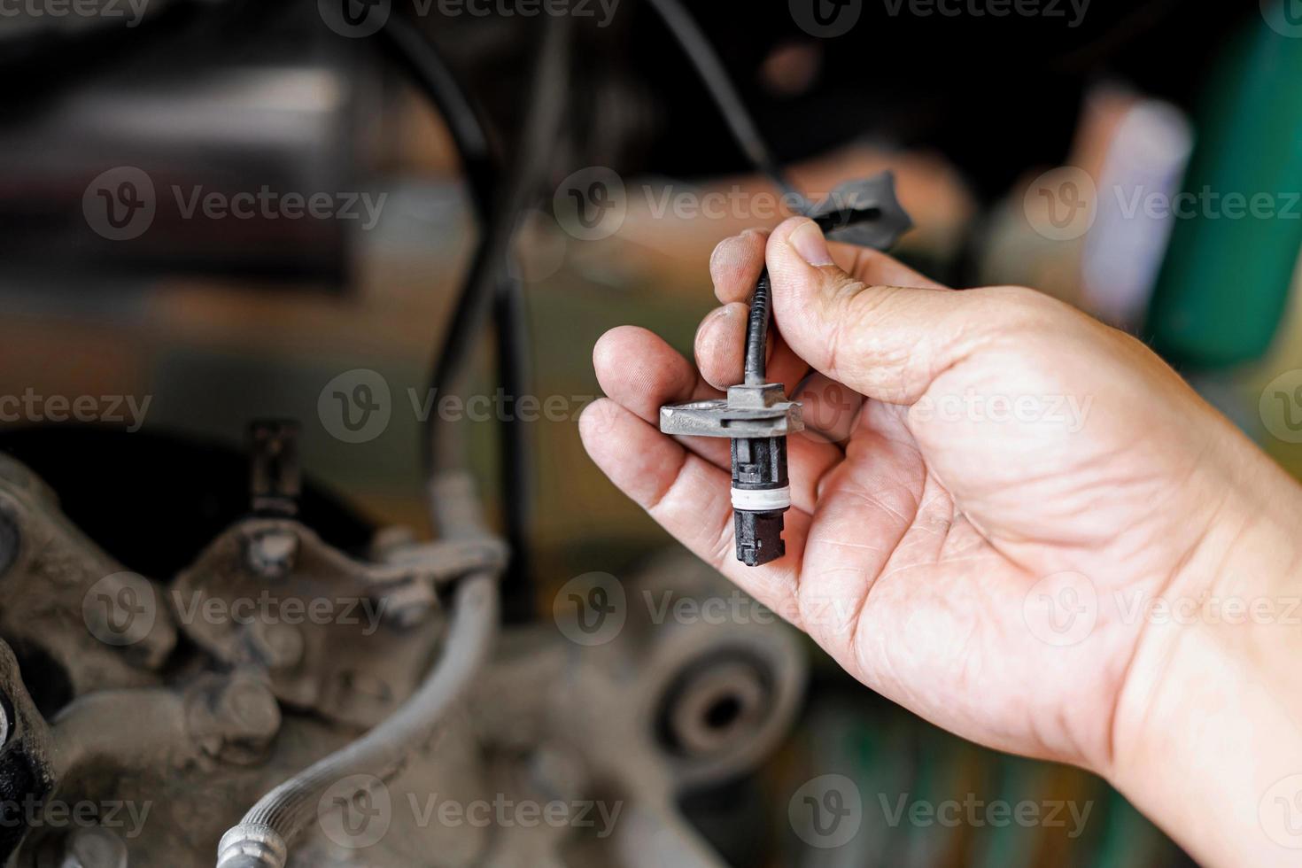 Close up ABS brake sensor of car wheel check for abnormalities to ensure the safety of the brakes service concept photo