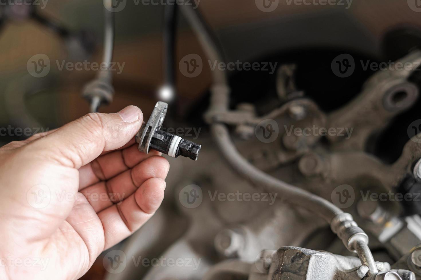 Close up ABS brake sensor of car wheel check for abnormalities to ensure the safety of the brakes service concept photo