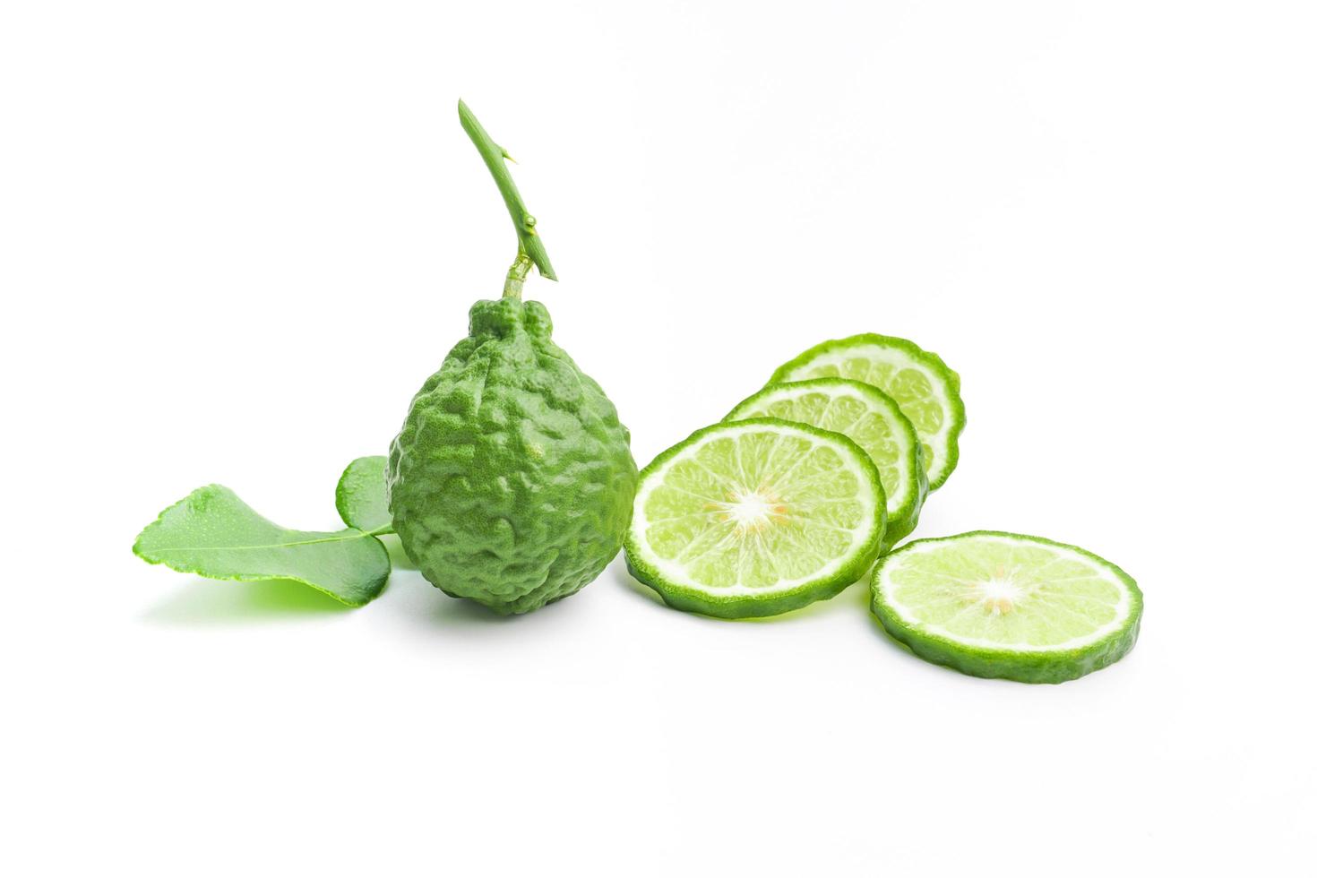 Bergamot and Kaffir lime leaves with natural wrinkles on white background photo